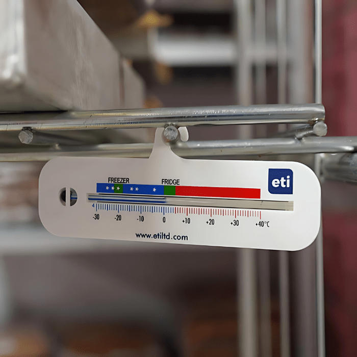 Un thermomètre Thermomètre.fr avec graduations allant de -30 à 40 °C, adapté à une utilisation au réfrigérateur-congélateur, monté sur une grille métallique.